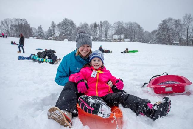 Maureen Wihry of Warwick and her daughter Emily Wihry, 7, are all smiles during their fun-filled afternoon of sledding at the park.