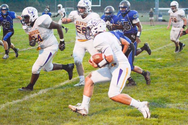 Photo by Al Konikowski Warwick quarterback Joe Miller follows his blockers during last Friday's non-league football game against Valley Central rushes. Wildcats held on for the 14-13 victory.