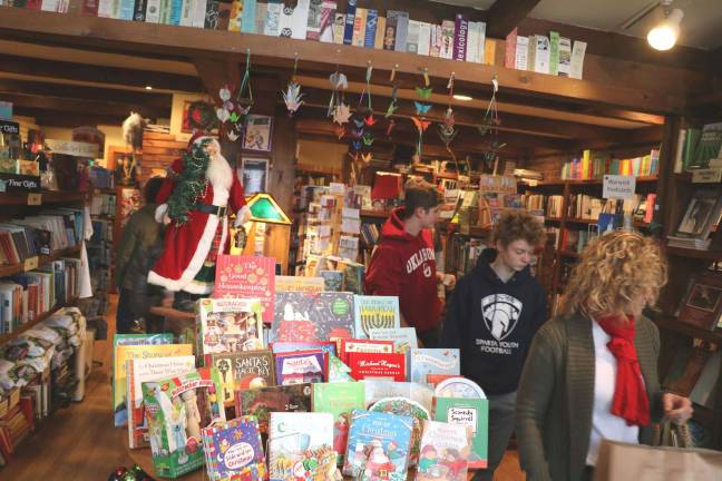 Merchant Guild President Tom Roberts, owner of Ye Olde Warwick Book Shoppe,(pictured here) reported that sales on Small Business Saturday were very good and the entire weekend should prove much better than last year.
