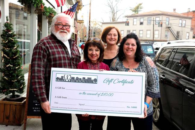 Photo by Roger Gavan Warwick merchant gift certificates can be last-minute solution for Christmas. Pictured in front, from left are: Merchant Guild President Tom Roberts, Home for the Holidays co-chairs Mary Beth Schlichting and Corrine Iurato; and just behind, Newhard&#x2019;s co-owner Beth Newhard.