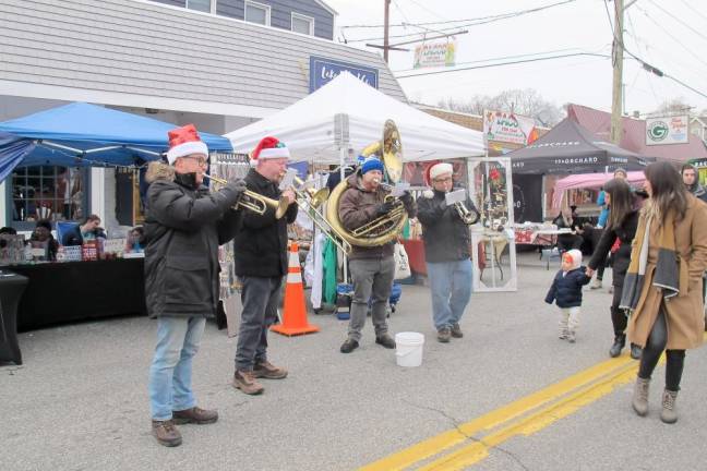 The “Brass Rascals” played their instruments along with the Christmas songs playing on speakers.