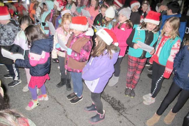 Local Brownies and Girl Scouts sing Christmas carols before the tree was lit.