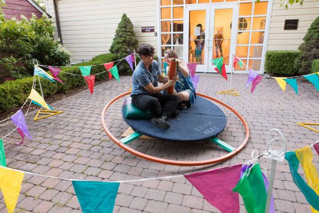 Photo by Argenis Apolinario DUSKLIT visitors riding on MaryAnne Carey and Corinna Ray&#x2019;s &#x201c;Come Say Hello&#x201d; at DUSKLIT 2016.