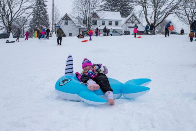 Alexis Obrotka of Warwick, 8, spent the afternoon sledding with her neighbor and her father. Her sled of choice? A unique, electric blue, narwhal-shaped tube.