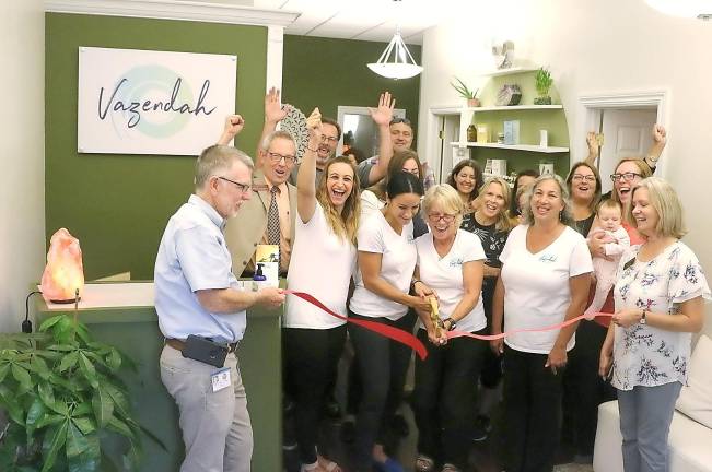 On Thursday, Sept. 12, Town of Warwick Supervisor Michael Sweeton (left) and members of the Warwick Valley Chamber of Commerce joined founders Mary Comerford-Hewitt and her daughter Jessica, (center) staff, friends, patrons and supporters to celebrate the Vazendah Wellness Center grand opening with a ribbon-cutting ceremony.