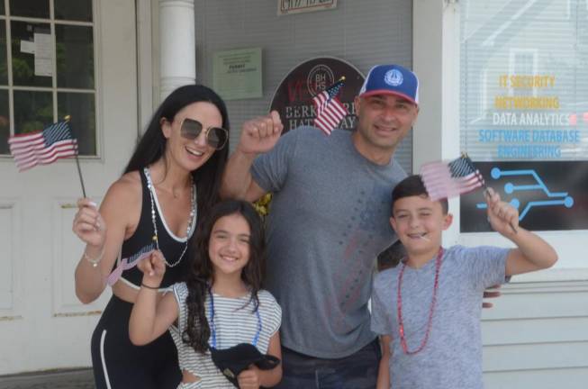 Watching the parade was the Castaldi family, including parents Jillian and John, with children Angelina, 7, and Francesco, 9, all holding their American flags.