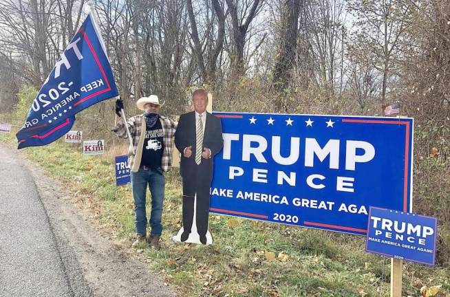 Andrew Goodman from Warwick spent much of Election Day on the side of Route 94 in Warwick promoting the re-election of President Donald Trump. Photo by Terry Reilly.