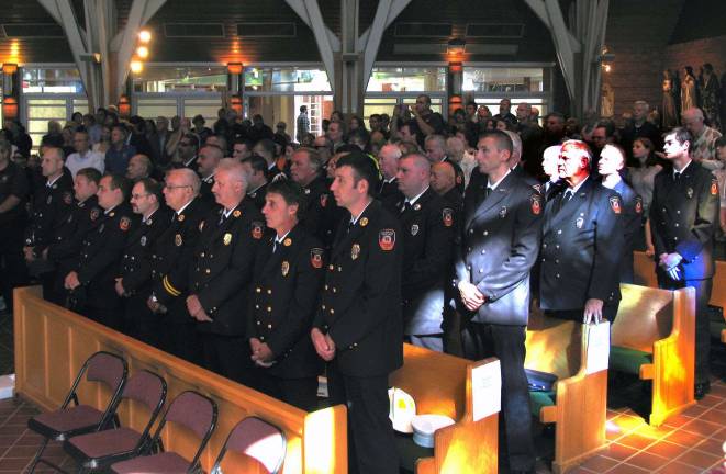 Officers and volunteers with the Warwick Fire Department attended the Mass in uniform to honor their chaplain.