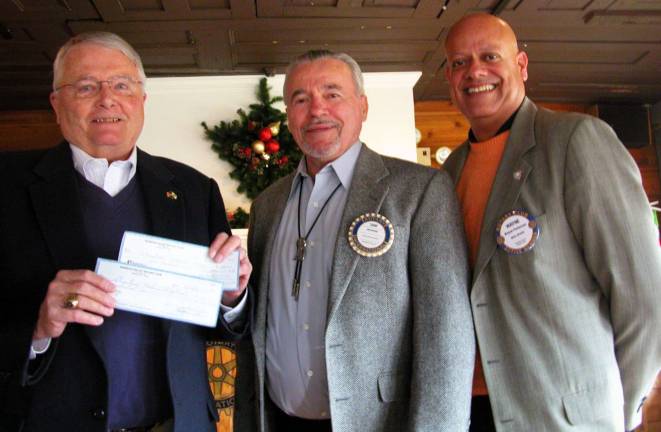 Photo by Stan Martin Past Rotary District Governor Knut Johnsen, left, accepts $1,500 in donations from the Warwick Valley Rotary Club for the International Medical Relief Foundation. Warwick Rotary President John Buckley and Immediate Past President Wayne Patterson made the presentations.