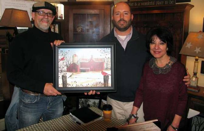 Photo by Roger Gavan' During his visit folk-artist Billy Jacobs (left), pictured with Frazzleberries co-owners Marybeth Schlichting and her son Jerry, displayed an extensive collection of his work, including newly released images of a Jessup Road farm.