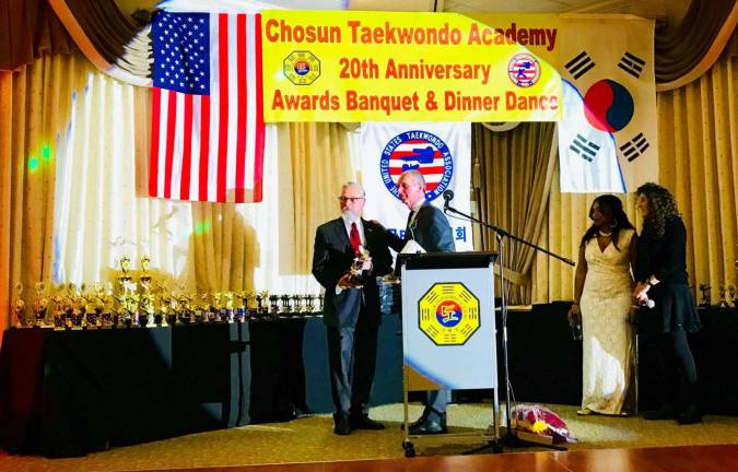 Provided photo Warwick Mayor Michael Newhard accepts the American Eagle Award from Grandmaster Doug Cook at the Chosun Taekwondo Academy's 20th anniversary Awards Banquet and Dinner Dance held Dec. 9 at Mineral&#x2019;s Resort &amp; Spa in Vernon, N.J.