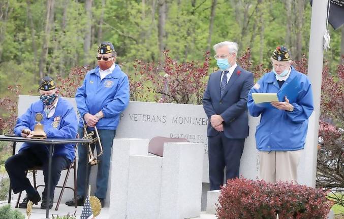 American Legion Post 214 Commander Jerry Schacher (right) conducted a brief ceremony featuring his reading of the names of all the comrades who had passed away since last year’s Memorial Day ceremonies. A Legion member rang a bell after each name.