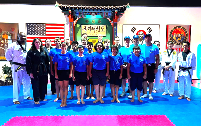 Warwick Junior Police Academy participants, along with Chosun instructors, at the Chosun Taekwondo Academy.