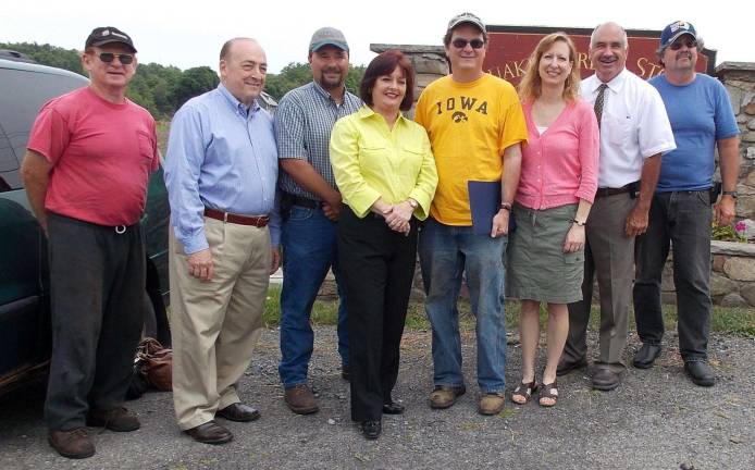 Assemblywoman Annie Rabbitt (center) honors local onion farmer and agricultural advocate Chris Pawelski (standing on her right). From left to right, they are joined by: John Lupinski from the Orange County Farm Bureau: Warwick Town Board member Floyd DeAngelo; Orange County Vegetable Growers Association President Paul Ruszkiewicz; the assemblywoman; Pawelski; his wife Chris Pawelski; Warwick Deputy Supervisor James Gerstner; and onion farmer Russell Kowal. Also in attendance but not pictured were John T. Redman, president of the Pine Island Chamber of Commerce; Diane Munro, superintendent of Florida School District; Diane Lupinski of Lupinski Farm; Michael Oates from Hudson River Ventures; and Richard Pawelski, Chris's father.