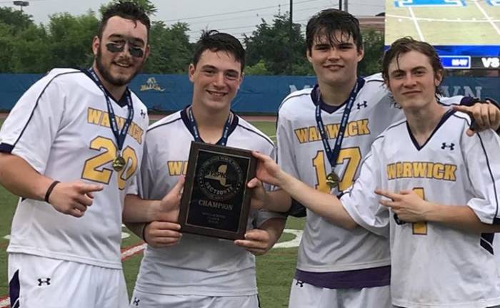 Provided photo The Warwick Valley Boys Varsity Lacrosse team defeated Minisink Valley 13-10 to claim its second Section 9 title in as many years. Pictured from left to right in a moment of celebration are team captains Anthony McGee, Matthew Hansen, Patrick Tully and Sam Steng.