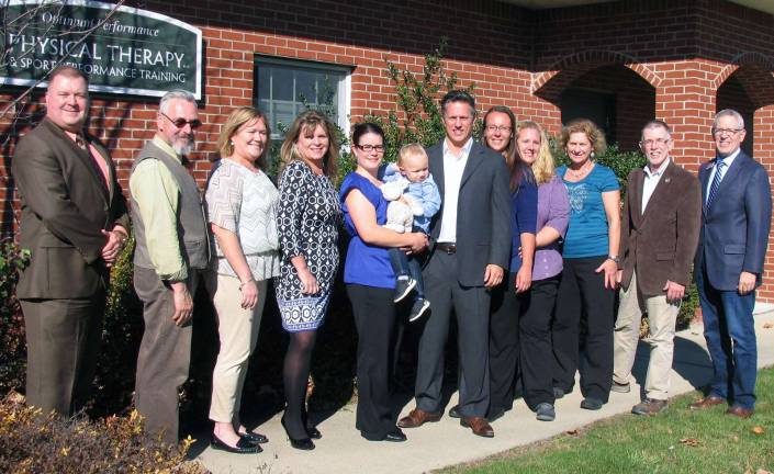 Photo by Roger Gavan On Nov. 4, Town of Warwick Supervisor Michael Sweeton (far right), Mayor Michael Newhard (second from left) and members of the Warwick Valley Chamber of Commerce joined Dr. Rick Rutkowski (center) and his staff to celebrate the 15th anniversary of Optimum Performance Physical Therapy.