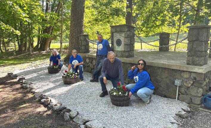 Rotarians add flowers to landscaping at Warwick Cemetery in preparation for Monday’s American Legion and VFW Memorial Day tributes to fallen military veterans.