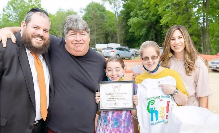 Chabad Hebrew School student Alan Schrank of Goshen, pictured with her parents David and Rachel, and Rabbi Pesach and Chana Burston at the Chabad Campus Groundbreaking Celebration.