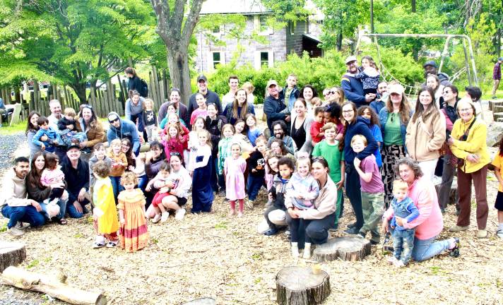 Melissa Reali, center, surrounded by the families that attend Playing Together Being Together classes.
