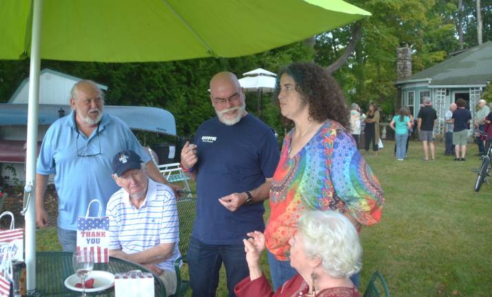 Warwick Town Board candidates Don Kilcoyne (standing center) and Dannie Sanisi (standing on the right) chat with area residents.