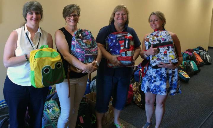 Photo provided by Catholic Charities Showing off some of the 65 backpacks donated by the parishioners of St. Stephen's Church in Warwick are, from left to right: Barbara Devine, Catholic Charities; Marla Silbernagel, St. Stephen's Parish; Lydia vanDuynhoven, St. Stephen's director of Religious Education; and Sheila Toohey, Catholic Charities.