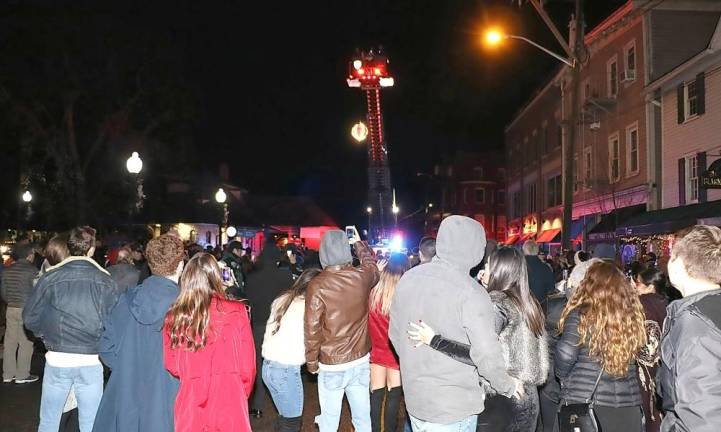 Many of those in the crowd joined Sesquicentennial Events Coordinator Mary Collura in the countdown as members of the Warwick Fire Department dropped the Warwick Apple.