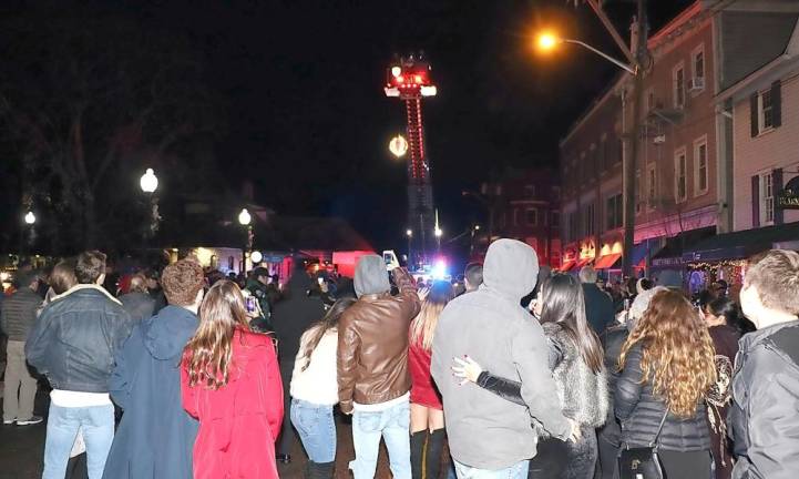 Many of those in the crowd joined Sesquicentennial Events Coordinator Mary Collura in the countdown as members of the Warwick Fire Department dropped the Warwick Apple.