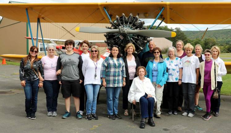 Photos by Roger Gavan Members of the North Jersey chapter of the &#x201c;Ninety Nines,&#x201d; an International organization of women pilots, pose by a PT 17, a WW II US Army primary pilot trainer, with Warwick Municipal Airport Manager Dave Mac Millan and World War II WASP member Kathleen Hilbrand, 93, (center) who flew this type of aircraft and other Army Air Force planes in 1944.