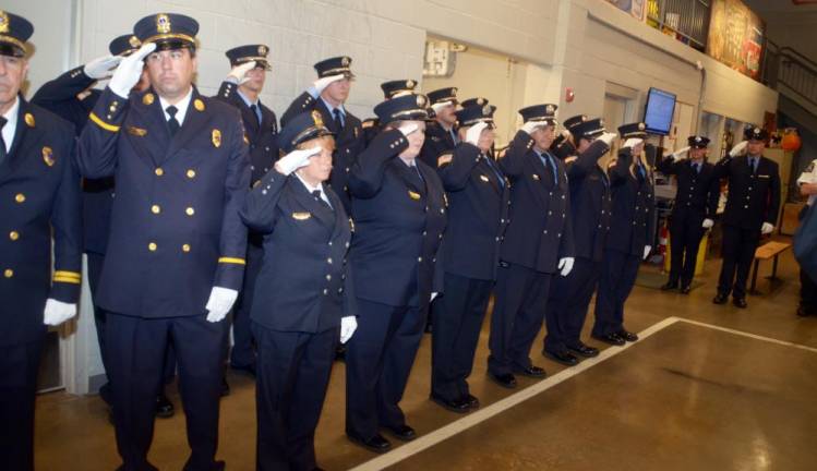 At the opening of the ceremony members of the Greenwood Lake Fire Department salute as they recite the “Pledge of Allegiance.” Photos by Ed Bailey.