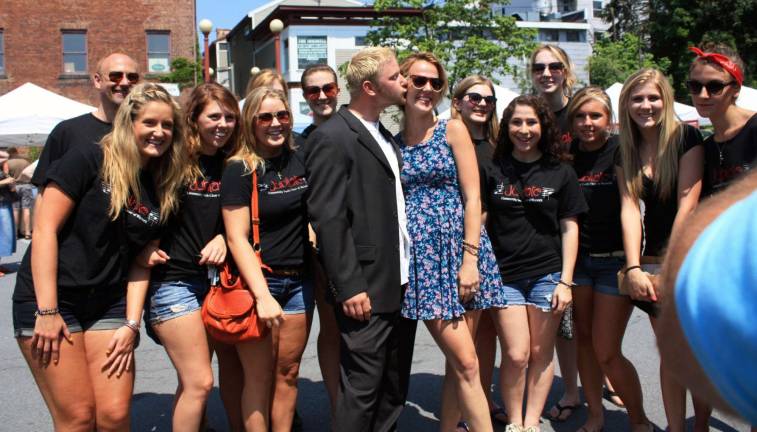 Photo by Tracey Lemon Members of the Jubilate youth choir helped Tom O'Donnell propose to his girlfriend Kristen Callahan last Sunday at the Warwick Farmers Market.