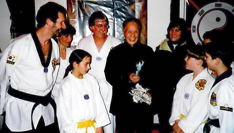 Grandmaster Doug Cook and Chosun Taekwondo Academy students present Master Jou Tsung Hwa with a gift in 1997 at the Warwick Tai Chi Farm.