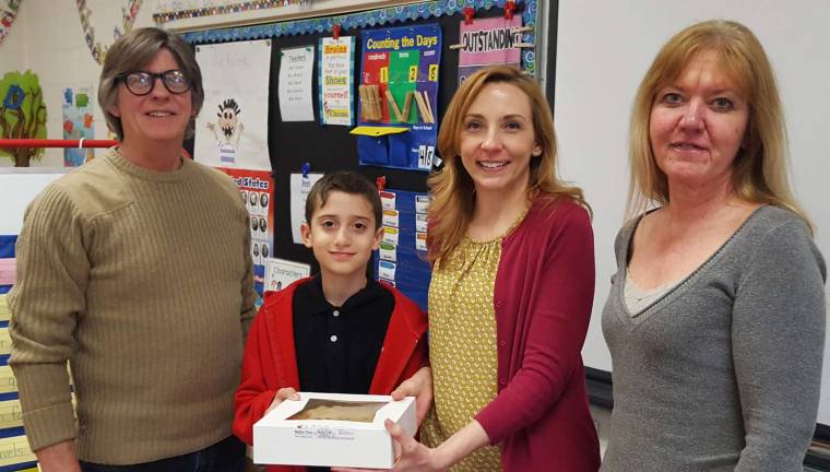 The owners of Noble Pies flank Sanfordville Elementary School student with Austin Tino and his teacher Lorna Nyland.