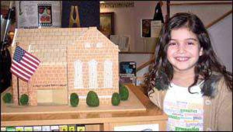 Student gives model to library