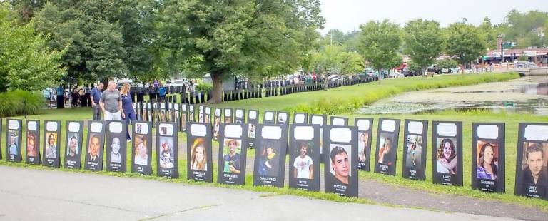 Black Posters with the faces of those who lost their lives from overdose lined the path of Monroe ponds and served as a chilling reminder of the overdose crisis. People were able to walk along and read their stories. Photos by Sammie Finch.