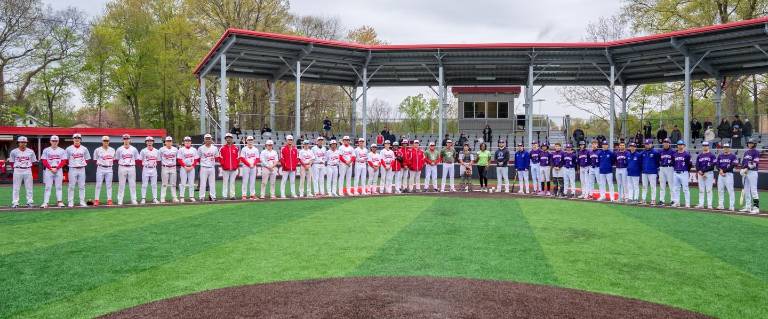Warwick and North Rockland baseball teams surround Wounded Warrior Tonya Oxendine prior to first pitch on Saturday April 25.