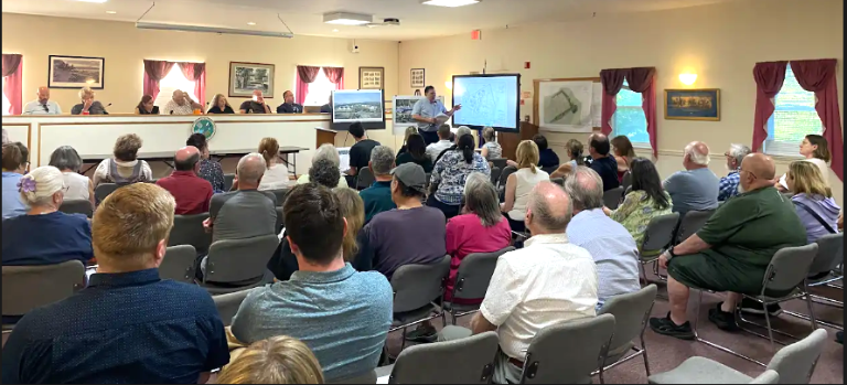 Crowd listens to an overview of proposed Blain Town Square project at the June 3 public scoping session.