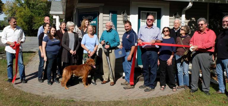 Pictured from left to right: Peter Hall; Johan Van Bladel; Charlie and Danielle Williams-Bell; Cristina Van Bladel; Joyce Groenendaal; Jeanette Shanahan; Perry Ricci&#x2019;s wife, Diana Sherwood holding companion dog, Buddy Boy; Dr. Perry Ricci holding ribbon cutting scissors; Orange County Legislator Paul Ruskiewicz; Pine Island Chamber President Leonard DeBuck; Janet Zimmerman; Peter Groenendaal; Mena Messina; Warwick Town Councilman Russell Kowal; and John Redman.