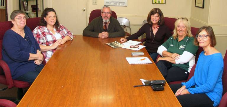 Photo by Roger Gavan Former members of the award-winning all girls band, the Queen Village Queens, recently met with Mayor Michael Newhard to organize the participation of other members to participate in Warwick's upcoming Sesquicentennial parade on Aug. 5, 2017. Clockwise from left are: Marion Langlitz Skinner, Colleen Daly, Mayor Michael Newhard, Pam Papaceno Arace, Deb Barth Gorish and Barbara Mirra.