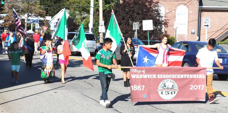 On Sunday afternoon, Sept. 24, a colorful assembly of members of the Spanish Ministry of the Warwick Reformed Church formed a line of march from the church down Main Street, in the Village of Warwick, to the Railroad Green.