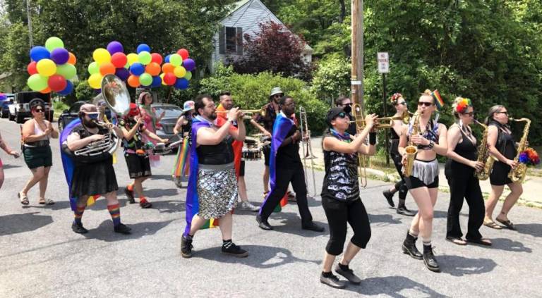 Funkrust Brass Band leads the crowd down the Pride parade route in Warwick.