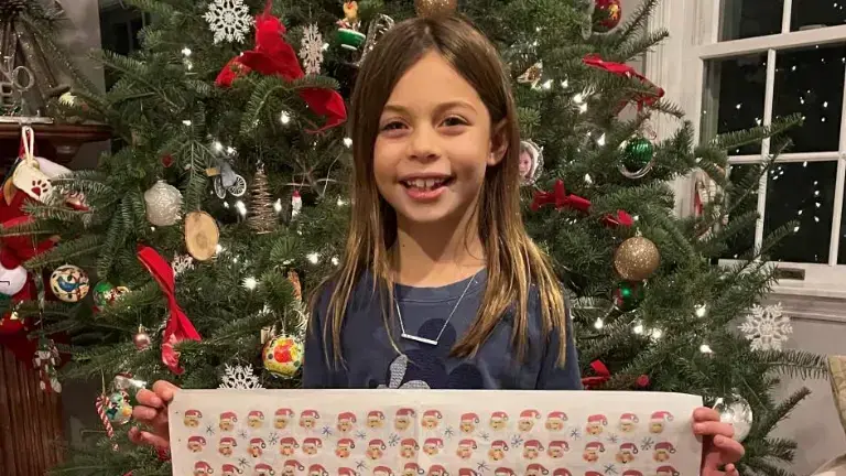 2021 contest winner Avery with her winning artwork printed as wrapping paper. File photo.