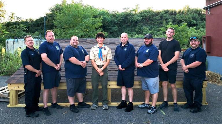From left to right: Lieutenant Charlie Moore, Lieutenant Joe Schweizer, Past Chief Andrew Lemin, Eagle Scout Holden Frommeyer, 1st Assistant Chief Kevin Hughes, 2nd Assistant Chief Marc Roe, Captain Austin Courtney, Firefighter Scott Lemin.