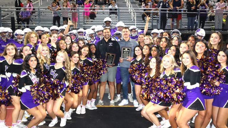 Warwick recognized John Garcia Jr., center left, and Johnny Babin, center right, the newest inductees into the Football Hall of Fame, prior to Friday night’s game.