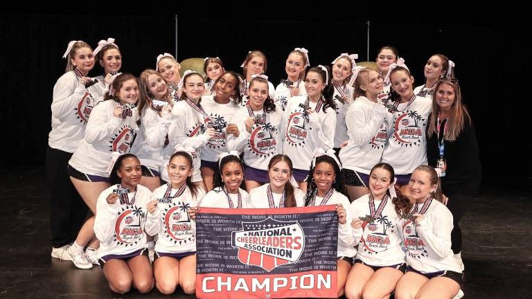 The Lady Wildcat cheerleaders celebrate as NCA champions.