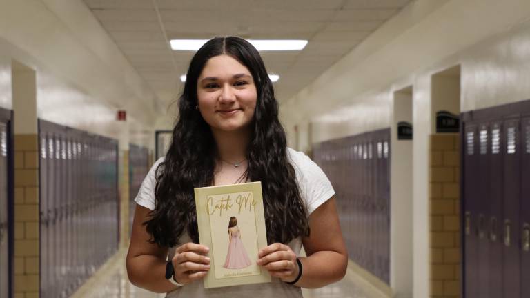 WVHS junior Isabella Costanza with her book, “Catch Me.”