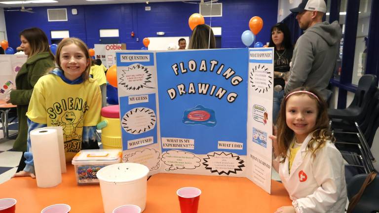 Sisters Lena and Zoe Radon show off their project at the Golden Hill Science Symposium.