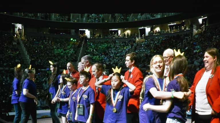Warwick Middle School fifth-graders receive their gold medals at the Odyssey of the Mind closing ceremony at Michigan State University May 24. From left: coaches Donna Denny and Rekha Woods, fifth-graders Verdigris Bisla, Molly Cook, Isaac Spicehandler, James Chavez-Carey, Mila Chan, Hailey Troy, Eliza Serafin.