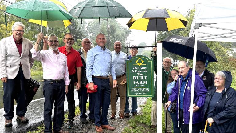 From left to right: Deputy Town Supervisor, Russ Kowal; Village of Warwick Michael Newhard; Town Councilman, Tom Mattingly; Village of Greenwood Lake Mayor, Tom Howley; Warwick Town Supervisor, Jesse Dwyer; Town Attorney, Robert Krahulik, Esq.; Town Councilman, Floyd DeAngelo; Danny McFarland; Abigail McFarland; Don McFarland; George Opper; Carol McFarland Stearn. Not shown were Town Police Department Officers, Sean McNamara and Brian Siniscalchi; and Tony Donato, who produced the sign.