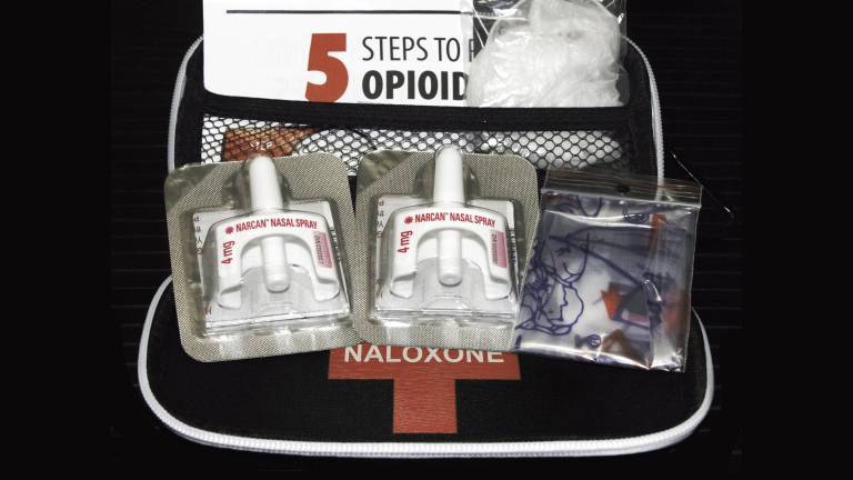 Naloxone nasal delivery method of Narcan distributed by healthcare professionals to help combat opioid crisis and reverse the effects of opioid overdose.