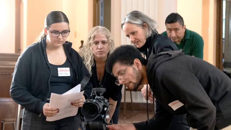 Marina Cilento of Carmel, N.Y., a sophomore Digital Media Production student (left), helps to film the oral history of four Maryknoll Sisters at the congregation’s Center House in October of 2025.